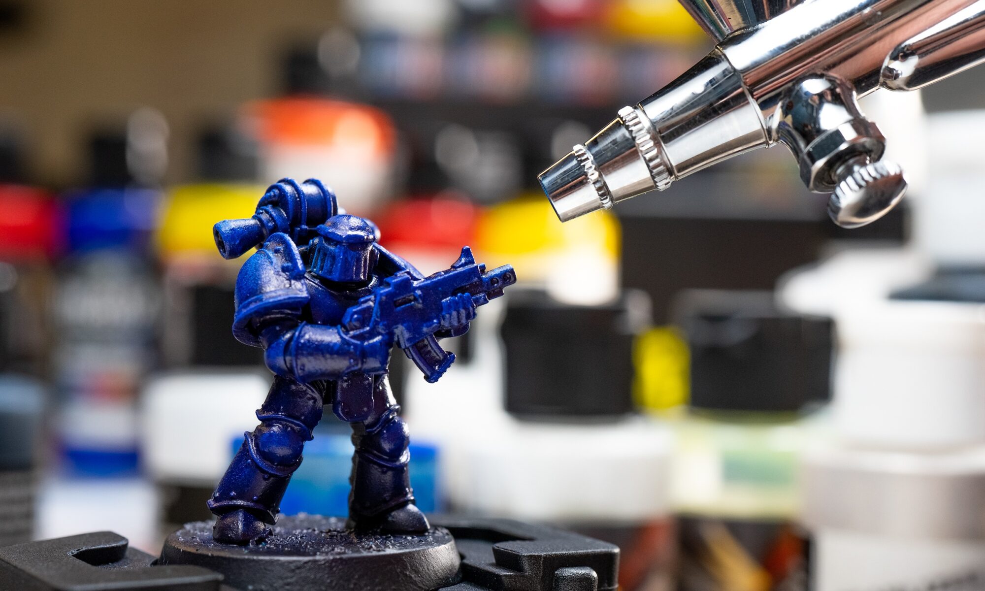 Close up of iwata gravity feed airbrush painting warhammer marine